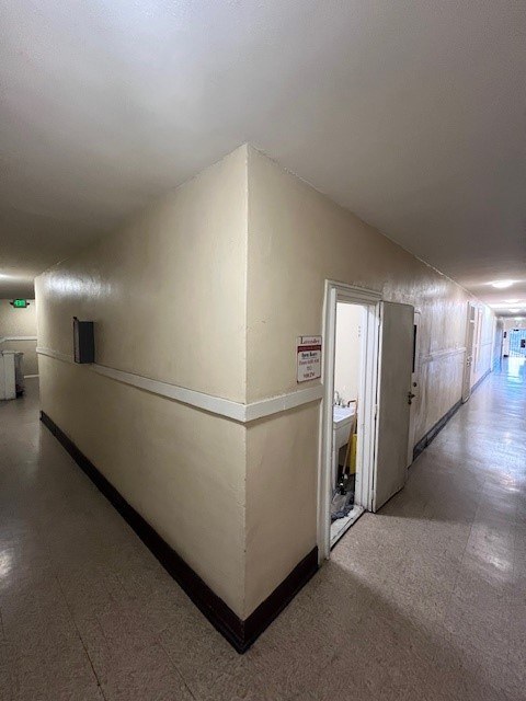 A long hallway with a door at the end.